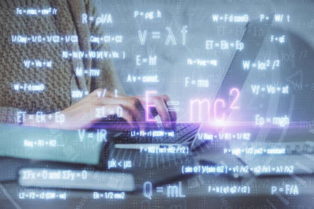 Double exposure of woman hands typing on computer and formula hologram drawing. Education concept.
