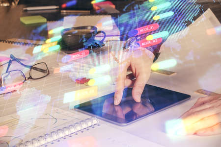 Double exposure of man's hand holding and using a digital device and data theme drawing. Technology...