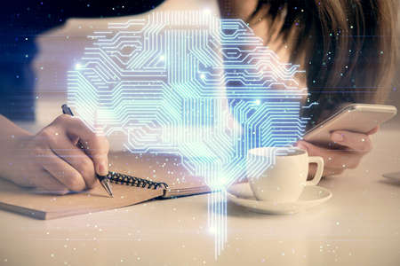 Double exposure of brain sketch hologram and woman holding and using a mobile device.