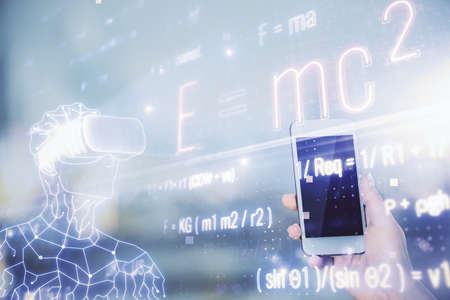 Double exposure of formulas sketch hologram and woman holding and using a mobile device. Education concept.の写真素材