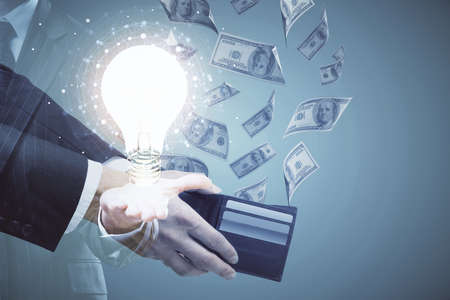 Multi exposure of bulb drawing hologram and USA dollars bills and man hands. Business Idea concept.
