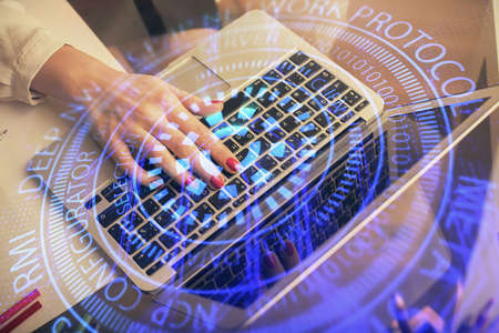 Multi exposure of woman hands working on computer and data theme hologram drawing. Tech concept.の写真素材