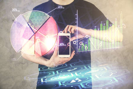 Double exposure of man's hands holding and using a digital device and forex graph drawing. Financial market concept.の写真素材