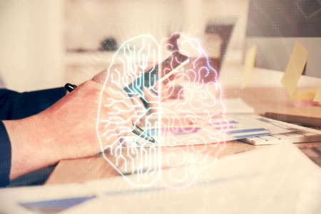 Double exposure of man's hand holding and using a digital device and brain hologram drawing. Data...