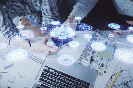 Double exposure of social network theme drawing and man and woman working together holding and using a mobile device.の写真素材