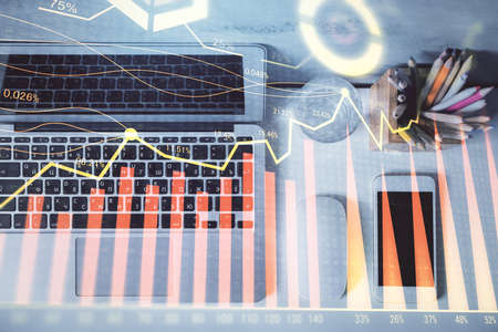 Multi exposure of forex graph drawing over desktop background with computer. Concept of financial...