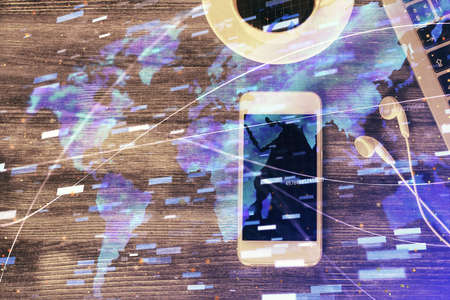 Double exposure of technology theme drawing over work table desktop. Top view. Global data analysis concept.の写真素材