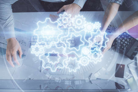 Double exposure of man and woman working together and business theme hologram drawing. Computer...