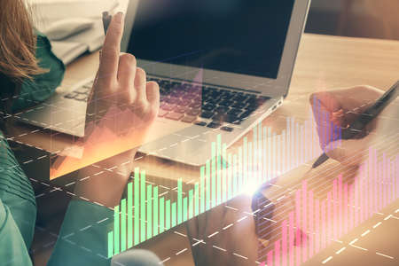 Double exposure of man and woman working together and forex chart hologram. Business concept. Computer background.の写真素材