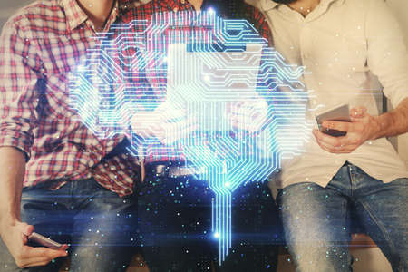 Double exposure of man and woman working together holding and using a mobile device and brain hologram drawing.の写真素材