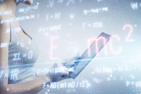 Double exposure of formulas sketch hologram and woman holding and using a mobile device. Education...