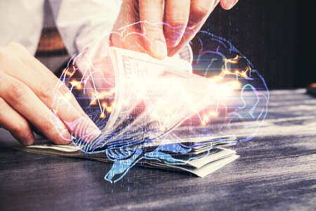 Multi exposure of brain drawing hologram and us dollars bills and man hands. Ai invest concept