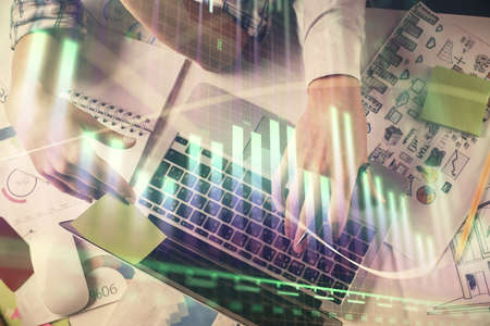 Double exposure of man and woman working together and forex graph hologram drawing. Financial...