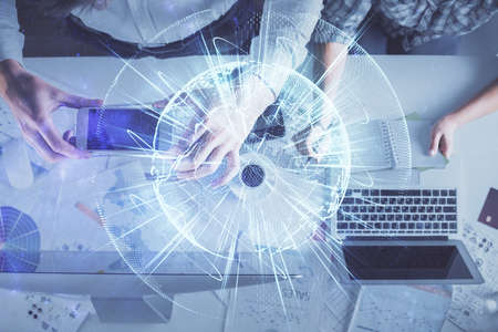 Double exposure of man and woman working together and business theme hologram drawing. Computer background. Top View.の写真素材