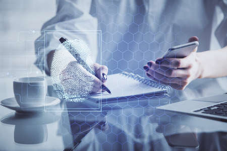 Double exposure of fingerprint hologram and woman holding and using a mobile device. Security...