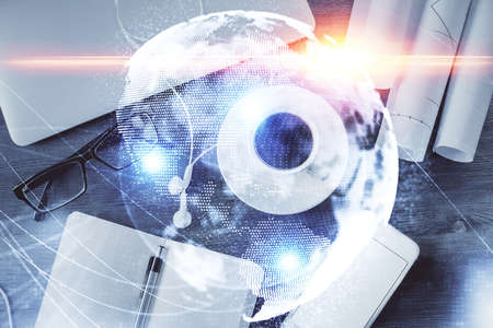 Business theme hologram drawings over computer on the desktop background. Top view. Multi exposure. Concept of international connections.の写真素材