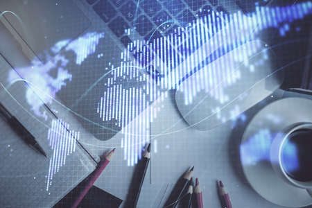 Business theme hologram drawings over computer on the desktop background. Top view. Multi exposure. Concept of international connections.の写真素材