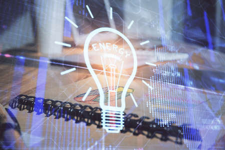 Double exposure of bulb drawing and desk with open notebook background. Concept of ideaの写真素材