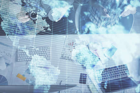 Double exposure of man and woman working together and business theme hologram drawing. Computer background. Top View.の写真素材