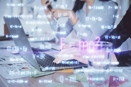Double exposure of woman hands typing on computer and formula hologram drawing. Education concept.の写真素材