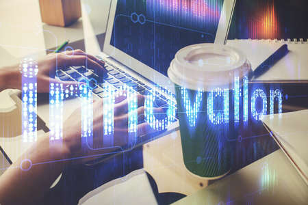 Double exposure of woman hands working on computer and data theme hologram drawing. Tech concept.の写真素材