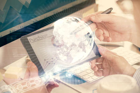 Multi exposure of man's hands holding and using a digital device and map drawing. International business concept.の写真素材