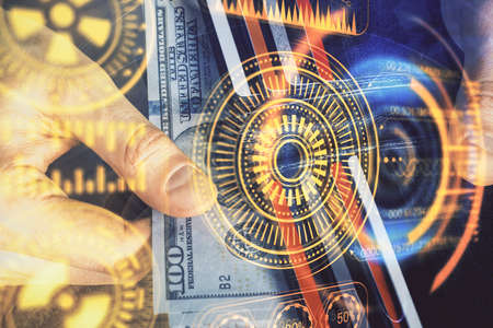 Multi exposure of Tech drawing hologram and USA dollars bills and man hands. Technology concept.の写真素材