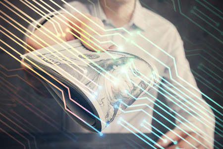 Double exposure of technology drawing hologram and us dollars bills and man hands. Data conceptの写真素材