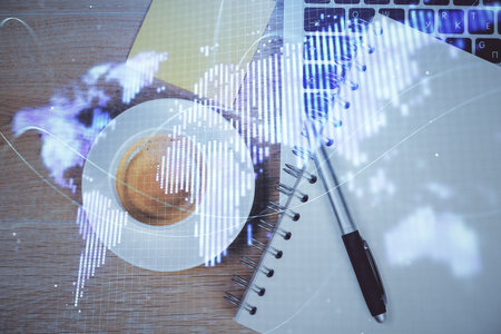 Business theme hologram drawings over computer on the desktop background. Top view. Multi exposure. Concept of international connections.の写真素材