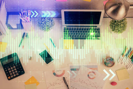 Double exposure of forex chart drawing over table background with computer. Concept of financial research and analysis. Top view.の写真素材