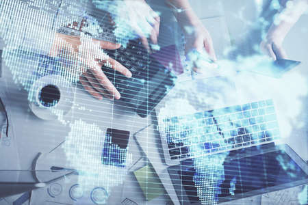 Double exposure of man and woman working together and business theme hologram drawing. Computer...