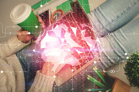 Double exposure of woman hands working on computer and brain hologram drawing. Ai concept.