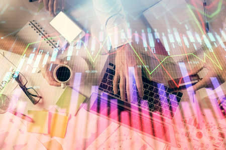 Double exposure of man and woman working together and forex graph hologram drawing. Financial...