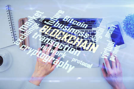 Double exposure of woman hands working on computer and blockchain theme hologram drawing. Top View....