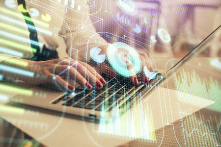 Multi exposure of woman hands working on computer and data theme hologram drawing. Tech concept.