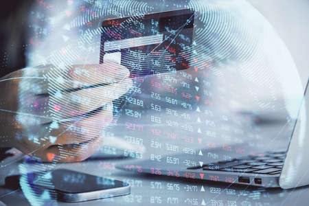 Multi exposure of woman on-line shopping holding a credit card and financial theme drawing. Business...