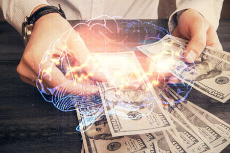 Multi exposure of brain drawing hologram and us dollars bills and man hands. Ai invest concept