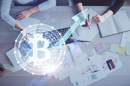 Double exposure of woman hands working on computer and blockchain theme hologram drawing. Top View....