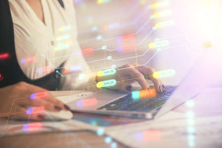 Multi exposure of woman hands working on computer and data theme hologram drawing. Tech concept.