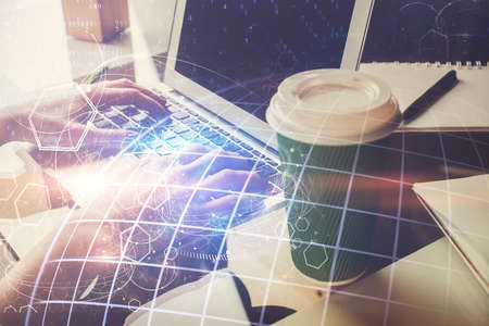 Double exposure of woman hands working on computer and world map hologram drawing. International...