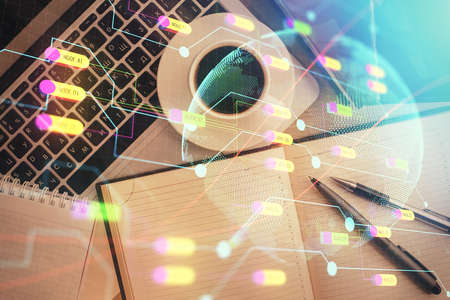 Double exposure of map hologram drawing over study table background with computer. Concept of international network. Top view.の写真素材