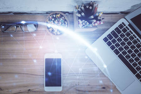 Double exposure of social network theme drawing over table with phone. Top view. People connecting concept.の写真素材