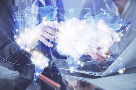 Double exposure of man and woman working together and financial theme hologram. international...