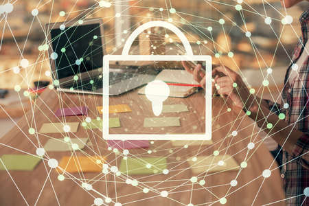Double exposure of woman hands working on computer and lock hologram drawing. Security concept.