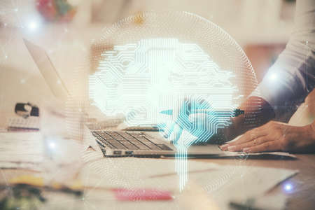 Multi exposure of woman hands working on computer and brain hologram drawing. Ai concept.
