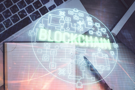 Blockchain theme hologram drawings over computer on the desktop background. Top view. Double exposure.の写真素材