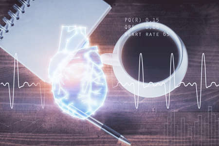 Double exposure of heart drawing and work table top veiw. concept of medical education.