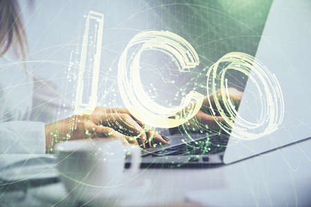 Double exposure of woman hands typing on computer and crypto market theme hologram drawing....