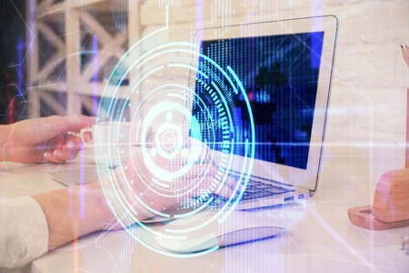 Double exposure of woman hands working on computer and data theme hologram drawing. Tech concept.