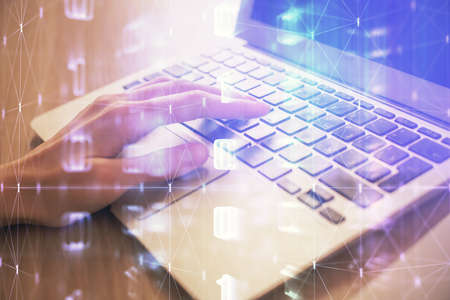 Double exposure of woman hands working on computer and data theme hologram drawing. Tech concept.